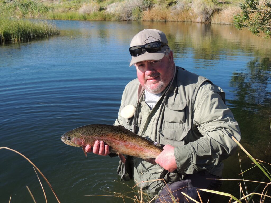 Jeremy Groh with a big still water rainbow trout. Photo by Gary Lewis