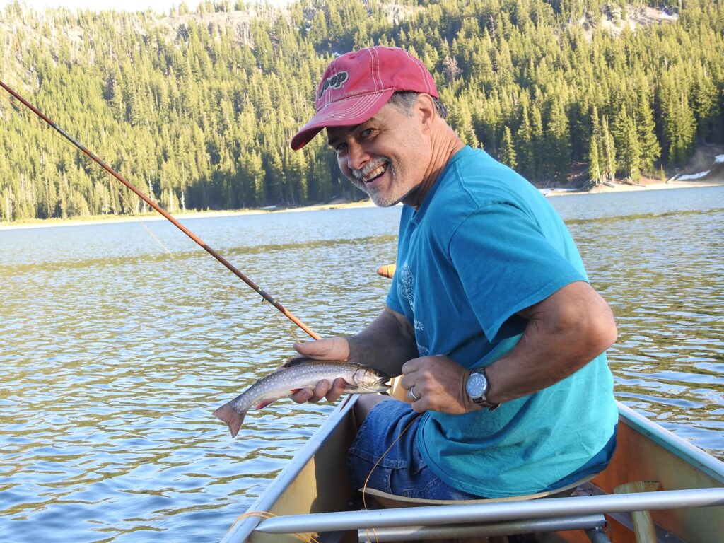 Jon Guenther with a fly-rod brookie. Photo by Gary Lewis